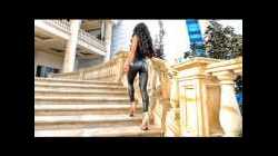 Walking in high heels.  Fitness Girl in leather leggings